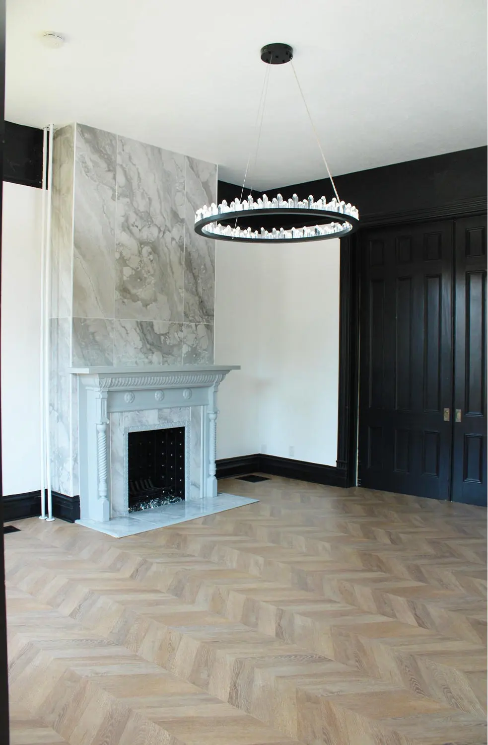 Suite with marble fireplace and herringbone floor