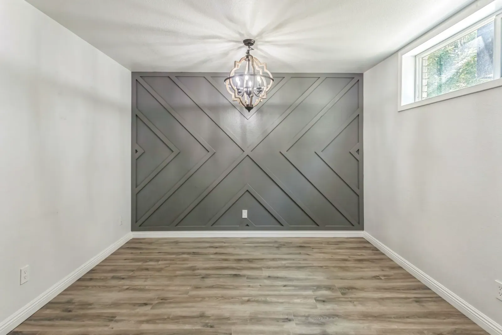 Office suite with geometric accent wall and chandelier